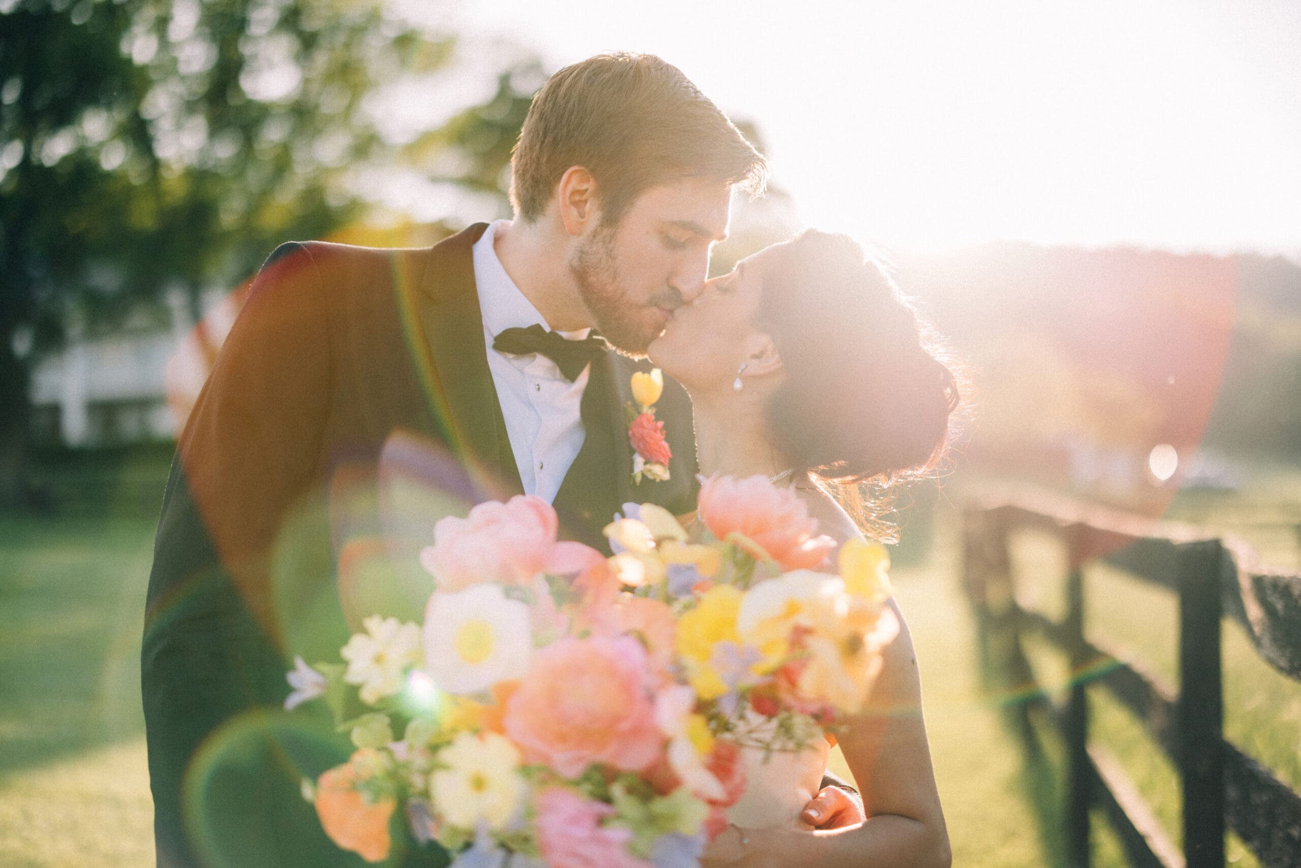 Wedding couple kiss during golden hour.