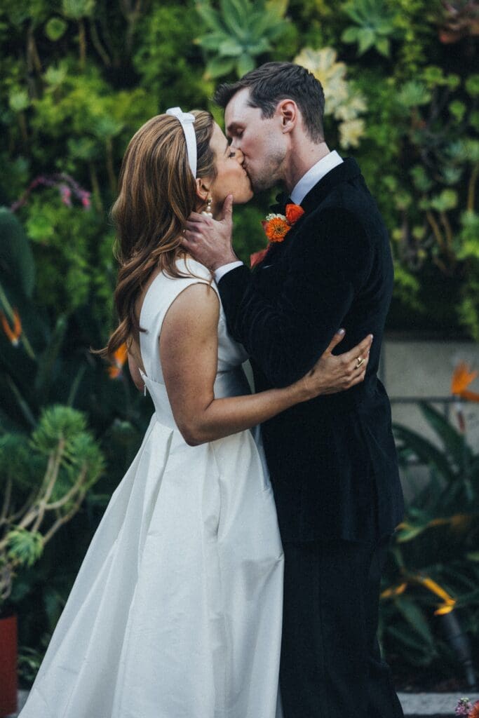 Newlyweds share a kiss after sealing their vows.