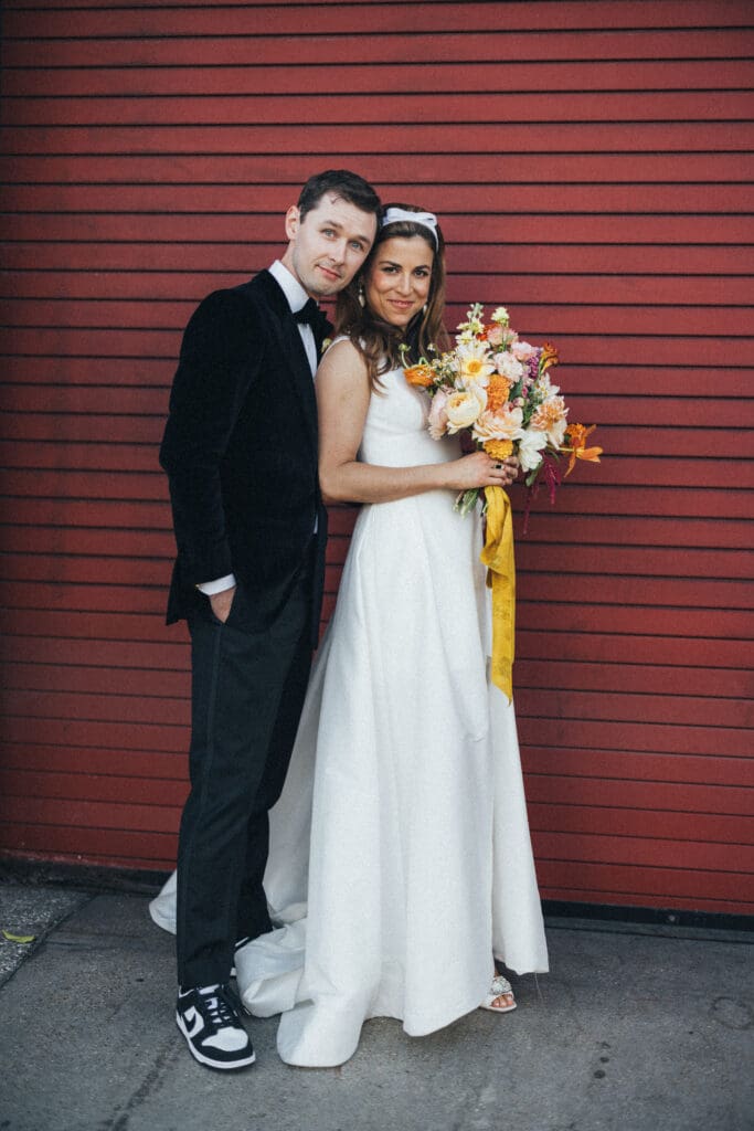 Bride and groom with flowers during couple portraits at SmogShoppe in Culver City.