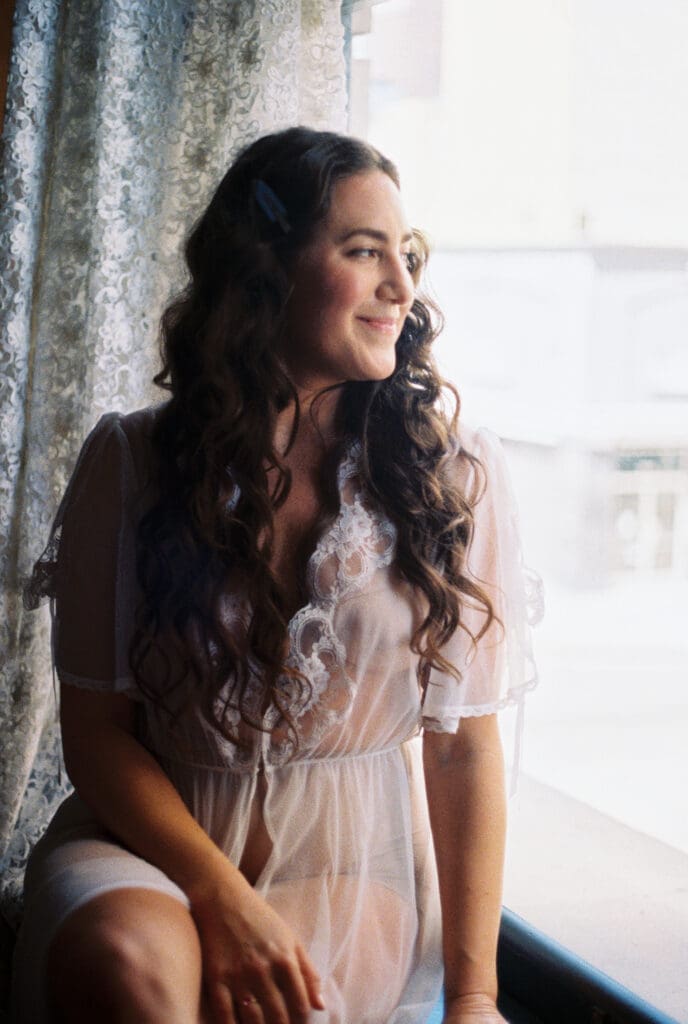 Bride smiling and getting ready at the Proper Hotel in DTLA with a vintage wedding dress.