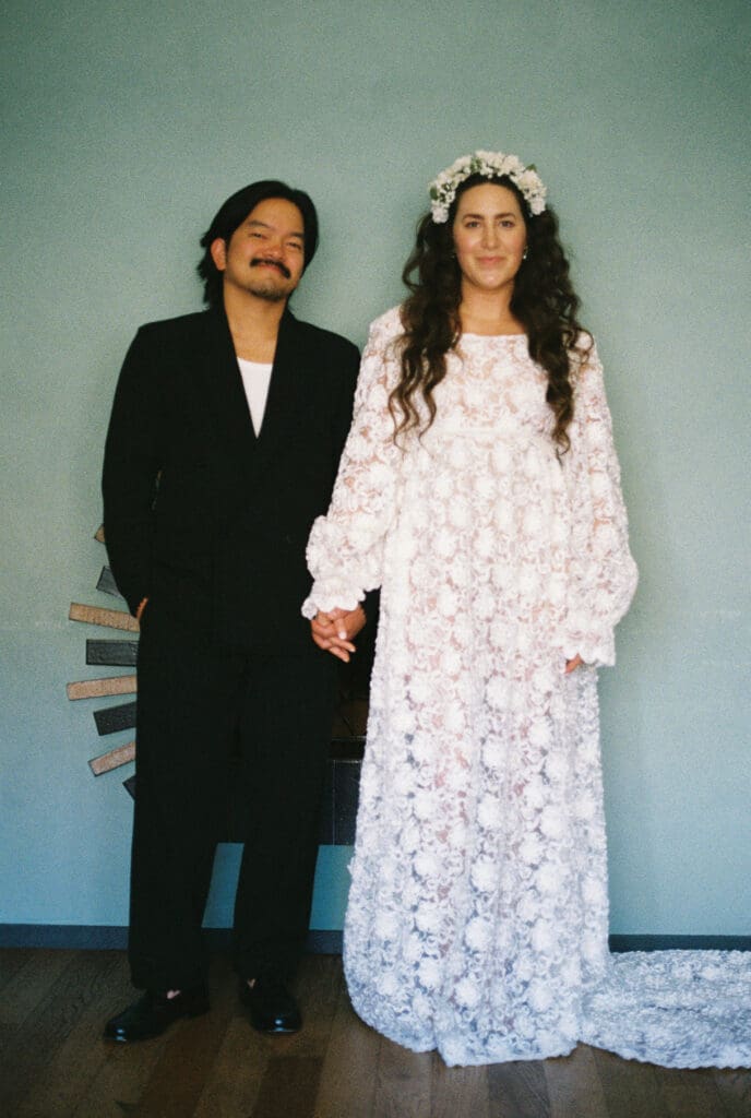 Bridge and groom shot on film holding hands at the Hotel Proper in Downtown Los Angeles.
