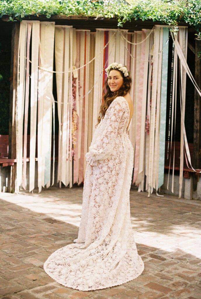 Beautiful photo of the bride wearing a lacy vintage wedding dress and flower crown, shot on film on her wedding day at Seventh/Place.