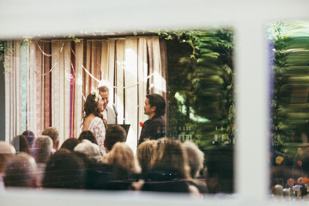 Colorful reflection shot of bride and groom at the wedding ceremony at Seventh/Place shot by California Wedding Photographer Abigail Gorden Photography.