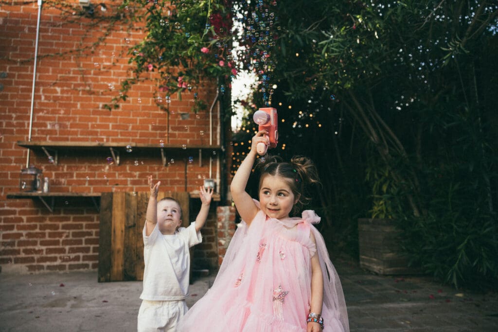 Cute little kids playing with bubbles at the wedding at Seventh/Place, DTLA.